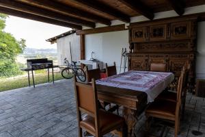 a wooden table and chairs on a patio at Villa Katalea - piscina privata e barbecue in Asti