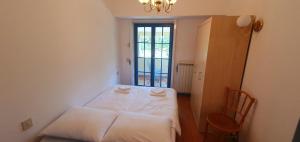 a small room with a bed and a window at Karsolina in Štanjel