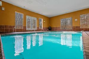 a large swimming pool with blue water in a building at Apalachee Pool lodge in Cosby