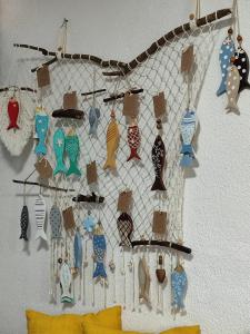 a rack of ornaments hanging on a wall at Maga hospedagem in Penha