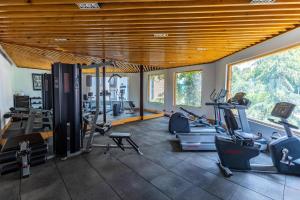 a gym with several treadmills and exercise bikes in it at Radisson Srinagar in Srinagar