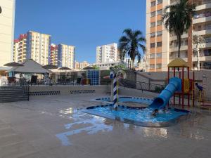 a water park with a slide and a playground at Eldorado Flat Service Host Hub | Localização Top em frente ao Clube Privé in Caldas Novas