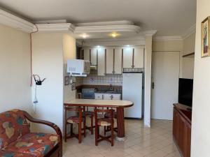 a kitchen with a table and chairs in a room at Eldorado Flat Service Host Hub | Localização Top em frente ao Clube Privé in Caldas Novas
