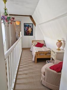a attic room with two beds and a staircase at Cosy cottage at rustic escapes 
