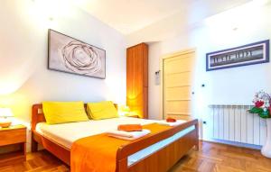 a bedroom with a bed with yellow and orange sheets at Beautiful Villa Ana with sea view in Crikvenica in Crikvenica