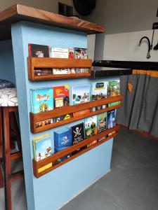 a book shelf filled with books in a kitchen at Maga hospedagem in Penha
