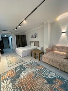 a room with two beds and a couch and a table at CHALET IN HURGHADA SCANDIC ReSORT in Hurghada