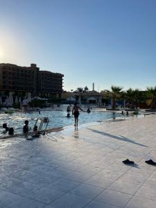 a person standing in the water at a swimming pool at CHALET IN HURGHADA SCANDIC ReSORT in Hurghada