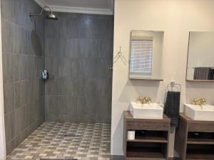 a bathroom with two sinks and a shower at DullVino Wellington House in Dullstroom +31 photos
