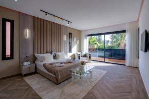 a living room with a couch and a glass table at Villa Mareva & Spa Marrakech in Marrakesh