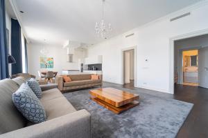 a living room with a couch and a coffee table at ZOYA LUXURY RESIDENCE in Budapest