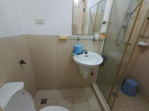 a bathroom with a toilet and a sink and a shower at Fully Furnished 1 Bedroom Condo Unit in Manila