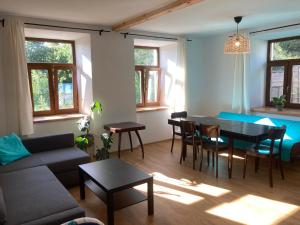 a living room with a couch and a table and chairs at Chalupa na konci ulice in Jindřichŭv Hradec