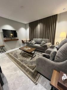 a living room with two couches and a tv at نزل الشمس in Jeddah