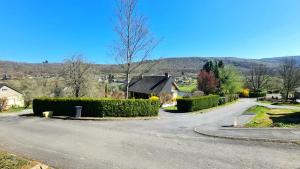 a winding road with a house in the distance at Chalet LE LIRY in Tournavaux