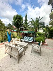 a group of chairs and tables and a playground at Sunrise Apartment in Batumi