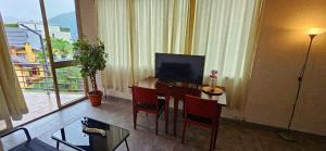 a living room with a desk with a computer on it at Apartment with two rooms and shared bathroom in Minusio +6 photos