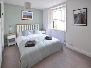 a bedroom with a large bed and a window at Cornerstones in Ambleside