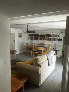 a living room with a couch and a table at Watchmaker Cottage in Bellingham +4 photos