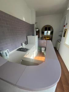 a kitchen with a white counter and a brick wall at Matilde house in Montecatini Terme +15 photos