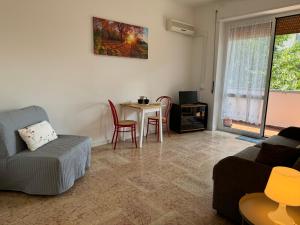 a living room with a couch and a table at Casa Lina Nolo - M2 - San Raffaele in Milan