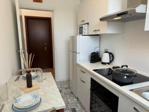 a kitchen with a counter with a sink and a refrigerator at Casa Lina Nolo - M2 - San Raffaele in Milan