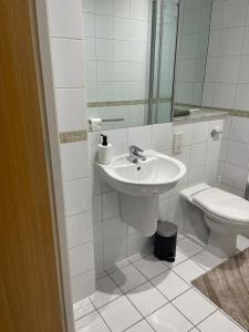 a bathroom with a sink and a toilet at Stylish 2Bedroom Flat - City Centre - Near Leeds Station in Leeds