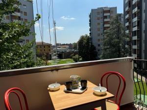 a table and chairs on a balcony with a view at Casa Lina Nolo - M2 - San Raffaele in Milan