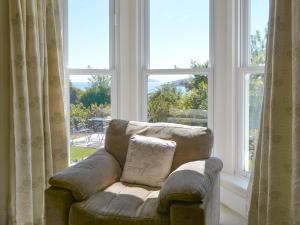 a couch sitting in front of a large window at Fairview in Rockcliffe