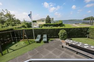 a patio with two benches and a swing at Sternlaan 8 Kamperland in Kamperland
