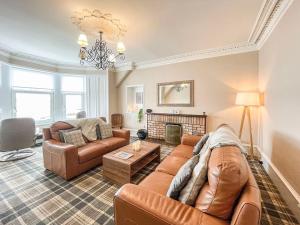 a living room with a couch and a table at Thornbank in Millport +20 photos