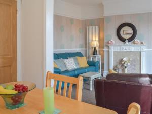 a living room with a couch and a table at Deja Blue in Filey