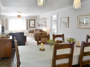 a dining room and living room with a table and chairs at Trelawny Court in Saint Minver