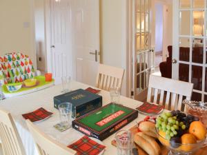 a table with a book and a bowl of fruit at Hawthorne House in Amble +14 photos