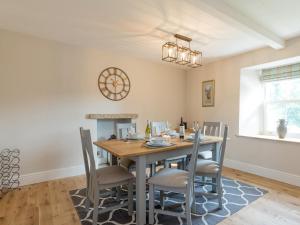 a dining room with a table and chairs at Abraham's Cottage in Low Eskcleth