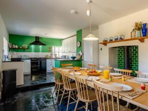 a kitchen and dining room with a table and chairs at The Retreat - M in Burton Bradstock