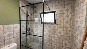 a shower with a glass door in a bathroom at Jugendstil Villa - 2 min zum Meer in Figueira da Foz +40 photos