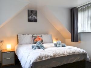 a bed with two pillows on it in a bedroom at Oak - Uk11993 in Greenhill +3 photos