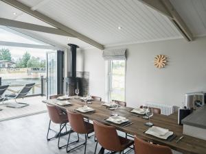 a dining room with a large wooden table and chairs at Brian Clough Lodge - Ukc4065 in Nunthorpe