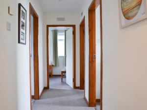 a hallway with two doors and a mirror at Cuckoos Nest in Cove