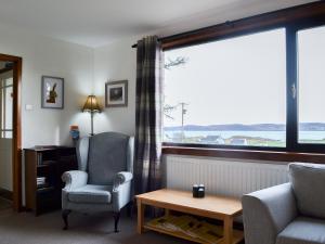 a living room with a couch and a chair and a window at Cuckoos Nest in Cove +15 photos
