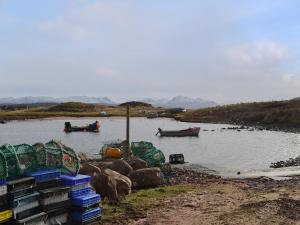 two boats in a body of water with rocks at Cuckoos Nest in Cove