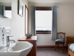a bathroom with a sink and a window at Cuckoos Nest in Cove