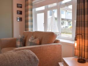 a living room with a couch and a window at The Captains Hideaway in Carew