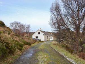 a house on the side of a dirt road at Cuckoos Nest in Cove