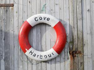 a red and white life preserver hanging on a wall at Cuckoos Nest in Cove