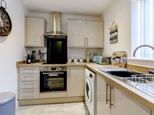 a kitchen with a sink and a stove at The Light House in Flamborough