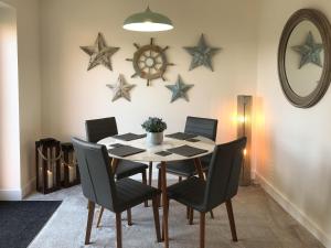 a dining room with a table and chairs and stars on the wall at The Light House in Flamborough
