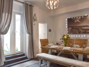 a dining room with a table and a window at Driftwood in Scarborough