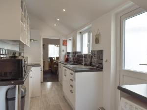 a kitchen with a sink and a counter top at Driftwood in Scarborough +28 photos